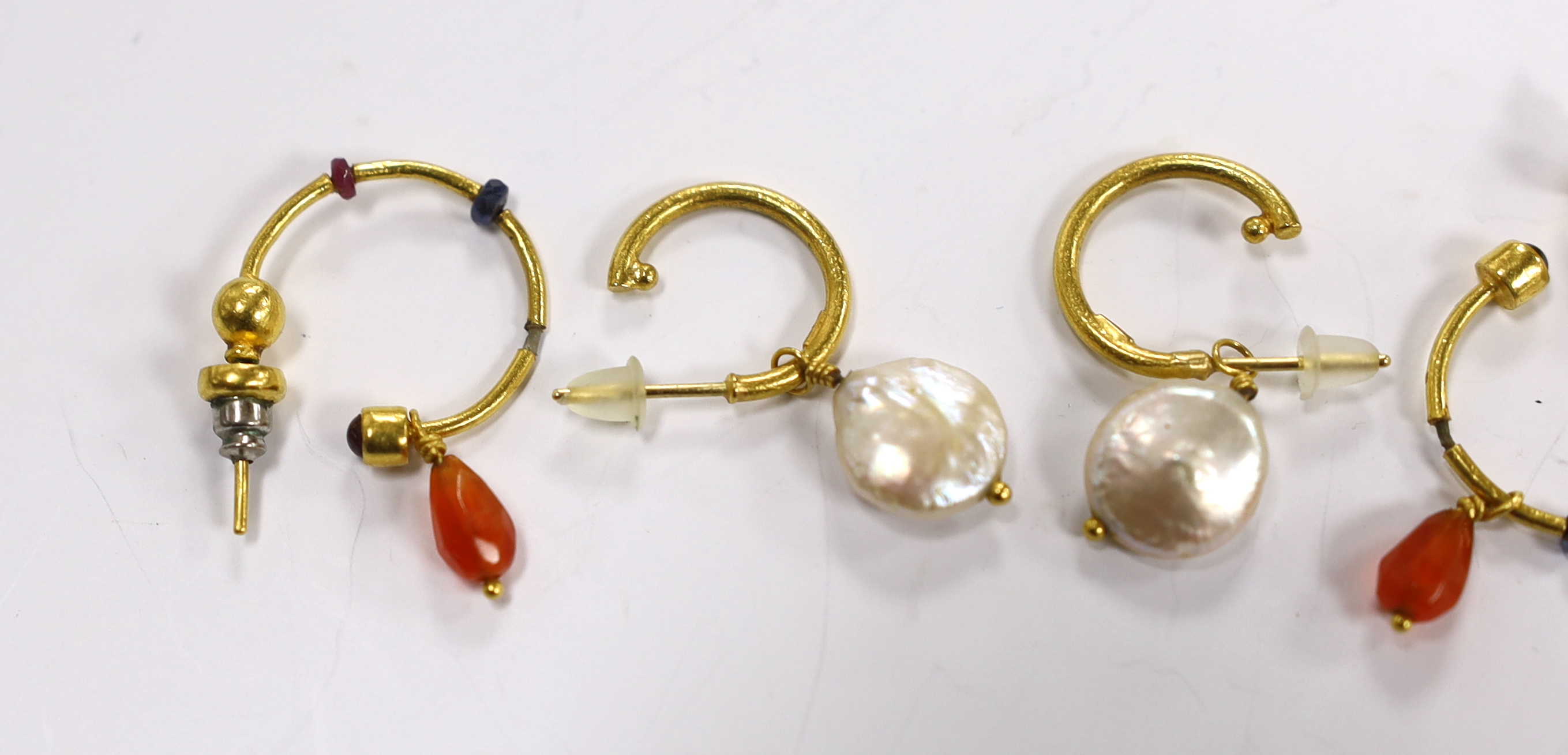 A pair of Middle Eastern 24k yellow metal and baroque cultured pearl set drop earrings, overall 31mm and one other pair of drop earrings.